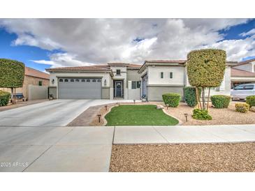 Charming single Gathering home with a two-car garage and landscaped front yard at 19736 E Emperor Blvd, Queen Creek, AZ 85142