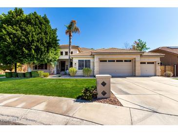 Beautiful single Gathering home features a well-manicured lawn and desert landscaping at 22139 N 80Th Ln, Peoria, AZ 85383