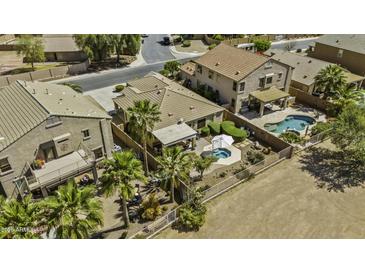 This home features a private backyard with a pool, spa, and desert landscaping at 22346 N Goles Dr, Maricopa, AZ 85138