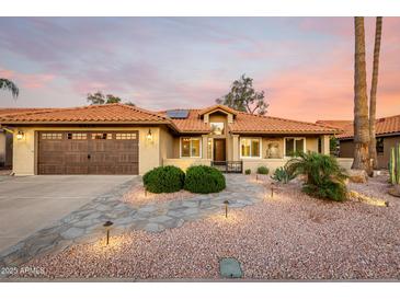 Charming single-story home featuring a desert landscape, tile roof, and an attached two-car garage at 2415 Leisure World --, Mesa, AZ 85206