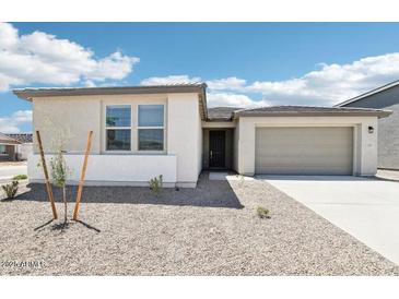 Inviting single-story home with a well-maintained front yard and attached two-car garage at 2707 E Abe Truckle Ave, San Tan Valley, AZ 85140