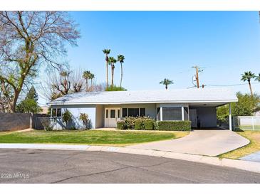 Charming single-story home with desert landscaping, a covered carport, and a light gray color scheme at 508 W Harmont Dr, Phoenix, AZ 85021