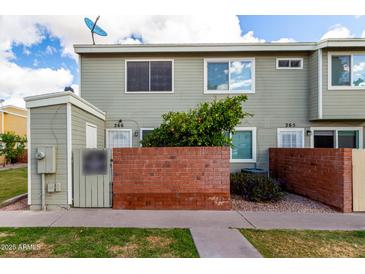 Charming townhome with brick accents, green shrubbery, and a lush lawn at 510 N Alma School Rd # 266, Mesa, AZ 85201