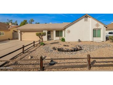 Charming single-story home with low maintenance desert landscaping, neutral paint, and an attached two-car garage at 5440 W Voltaire Dr, Glendale, AZ 85304