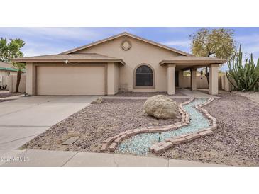 Charming single-story home featuring a low-maintenance rock yard and appealing desert landscaping at 6433 W Beverly Ln, Glendale, AZ 85306