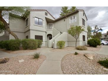 Inviting two-story condo featuring desert landscaping and private entryways, creating a welcoming first impression at 9455 E Raintree Dr # 2032, Scottsdale, AZ 85260
