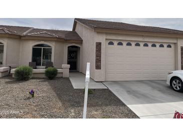 Charming single-story home featuring a two-car garage and neutral color palette with a quaint front porch at 10960 E Monte Ave # 283, Mesa, AZ 85209