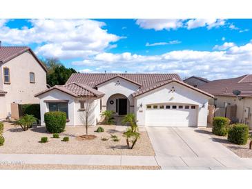 Charming single-story home with a well-manicured front yard and neutral color palette at 11207 N 165Th Ave, Surprise, AZ 85388