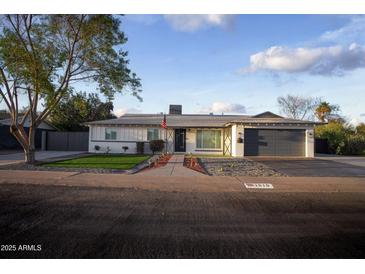 Charming single-story home featuring fresh paint, a landscaped yard, and a two-car garage at 1610 W Dunlap Ave, Phoenix, AZ 85021