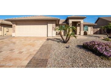 Beautiful single-story home featuring manicured landscaping, brick accents, and attached two-car garage at 3061 S Elderwood --, Mesa, AZ 85212