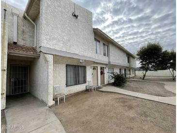 The exterior of this home features a stucco facade, two-story architecture, and well-maintained landscaping at 3840 N 43Rd Ave # 73, Phoenix, AZ 85031