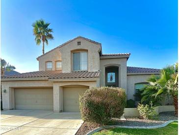 Charming two-story home with a well-manicured lawn, desert landscaping, and a spacious three-car garage at 641 W Oriole Way, Chandler, AZ 85286