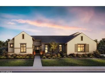 Charming single-story home with a stone entryway, manicured lawn, and inviting curb appeal at 10242 N 58Th St, Paradise Valley, AZ 85253