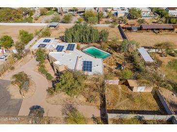 Expansive property featuring a refreshing pool and solar panels for energy efficiency at 11823 N 76Th Way, Scottsdale, AZ 85260