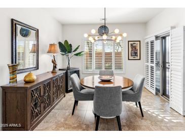Elegant dining area features modern lighting, stylish chairs, and tasteful decor, perfect for entertaining at 1475 N Agave St, Casa Grande, AZ 85122