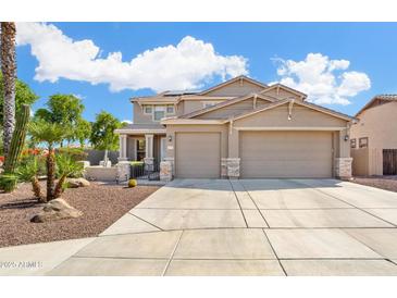Charming two-story home with a three-car garage and desert landscaping at 25776 N Sandstone Way, Surprise, AZ 85387