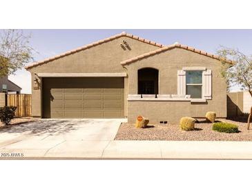 Charming single-story home featuring a two-car garage and well-maintained landscaping at 37236 N Navarra Rd, San Tan Valley, AZ 85140