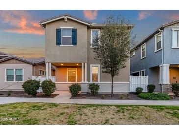 Charming two-story home with neutral siding, blue shutter, manicured landscaping, and inviting front porch at 3802 E Stiles Ln, Gilbert, AZ 85295