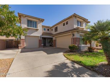 Charming two-story home with a three-car garage and well-manicured landscaping at 502 E Kona Dr, Casa Grande, AZ 85122