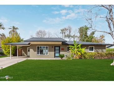 Charming single-story home featuring a well-maintained lawn, desert landscaping, and a convenient carport at 520 W Townley Ave, Phoenix, AZ 85021