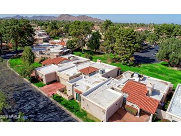 An aerial view of a condo community with well-maintained lawns and mature shade trees at 7350 E Arlington Rd, Scottsdale, AZ 85250