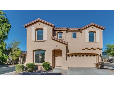 Charming two-story home with a two-car garage, desert landscaping, and neutral earth-tone exterior at 17025 W Rimrock St, Surprise, AZ 85388