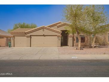 Charming single-story home with three-car garage, desert landscaping and neutral paint at 1756 E Cardinal Dr, Casa Grande, AZ 85122