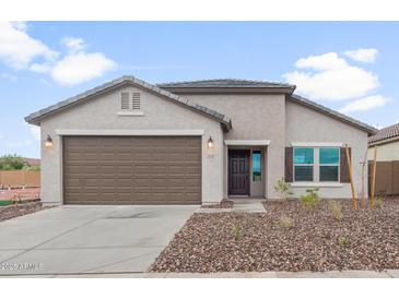 Charming single-story home featuring a two-car garage and a well-manicured front yard at 2638 N Coronado Dr, Florence, AZ 85132