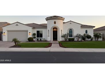 Charming home features a turret entryway, lush landscaping, and an attached two-car garage at 3675 E Strawberry Dr, Gilbert, AZ 85298