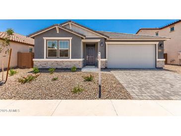 Charming single-story home featuring a stone-accented facade and a well-maintained desert landscape in the front yard at 40531 W Michaels Dr, Maricopa, AZ 85138