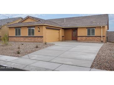 Charming single-story home featuring a two car garage and inviting entryway at 4067 N Ghost Hollow Way, Casa Grande, AZ 85122