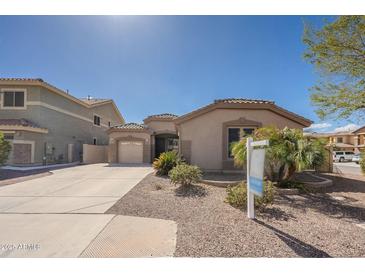 Inviting single-story home with a two-car garage and desert landscaping at 44383 W Windrose Dr, Maricopa, AZ 85138