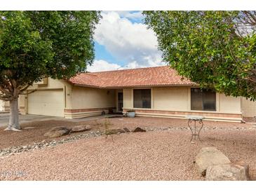 Charming single-story home features desert landscaping and a red tile roof at 5658 E Fairbrook St, Mesa, AZ 85205