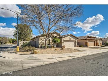 Charming single-story home featuring a xeriscaped front yard with a mature shade tree on a corner lot at 6198 W Wikieup Ln, Glendale, AZ 85308