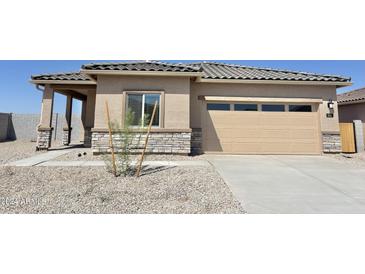 Charming single-story home featuring a two-car garage and desert landscaping at 666 W Pintail Dr, Casa Grande, AZ 85122