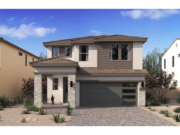 Modern two-story home featuring a gray garage door and a well-manicured desert landscape at 7988 W Griswold Rd, Peoria, AZ 85345