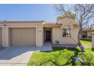 Charming single-level home with a well-maintained lawn and a covered front entry at 1021 S Greenfield Rd # 1213, Mesa, AZ 85206