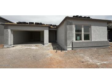 Exterior view of new home construction with a two-car garage and stucco facade at 11426 E Utopia Ave, Mesa, AZ 85212