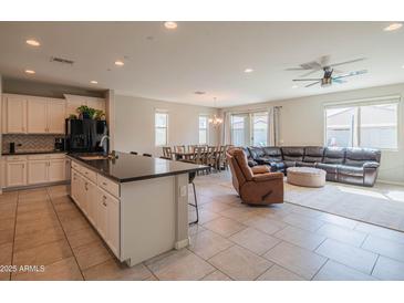 Open kitchen with a central island, seamlessly connected to the dining and living areas at 18187 W Via Montoya Dr, Surprise, AZ 85387