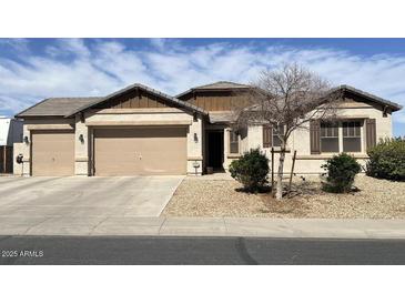 Charming single-story home with a three car garage and desert landscaping for low maintenance appeal at 18542 W Luke Ave, Litchfield Park, AZ 85340