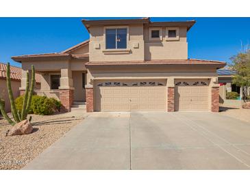 Two-story home featuring a three-car garage, low maintenance yard, and classic desert landscaping at 22236 N 48Th St, Phoenix, AZ 85054