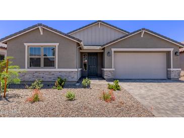 Charming single-Gathering home with stone accents, desert landscaping, and a two-car garage at 40499 W Michaels Dr, Maricopa, AZ 85138