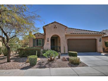 Charming single-story home featuring desert landscaping, a tile roof, and an inviting arched entryway at 4361 N Petersburg Dr, Florence, AZ 85132