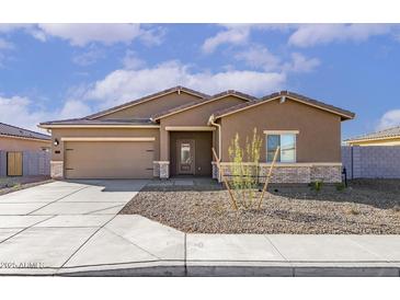 Charming single-story home with a neutral color scheme, xeriscaped yard, and attached two-car garage at 619 W Pintail Dr, Casa Grande, AZ 85122