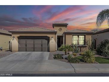 Charming single-story home featuring desert landscaping, a two-car garage, and a warm, inviting facade at 830 E Garden Basket Dr, Queen Creek, AZ 85140