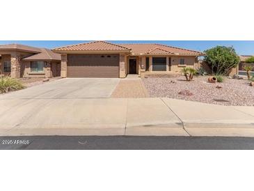 Charming single-story home featuring a well-maintained front yard and attached two-car garage at 10918 E Oro Ave, Mesa, AZ 85212