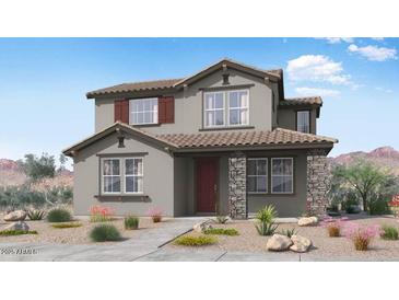 Charming two-story home featuring stone accents, a red front door, and desert landscaping at 14636 W Sand Hills Rd, Surprise, AZ 85387