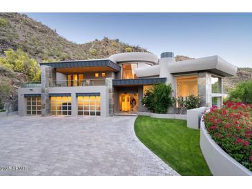 Stunning modern home featuring a unique architectural design, a spacious driveway, and lush landscaping at 4550 E Foothill Dr, Paradise Valley, AZ 85253