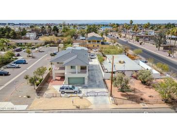 An elevated view of a two-story home that includes a gated driveway and second-story balcony at 5338 N 21St Ave, Phoenix, AZ 85015