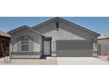 Charming single-Gathering home featuring a two-car garage and neutral-toned stucco exterior at 5839 W Willow Ridge Dr, Laveen, AZ 85339